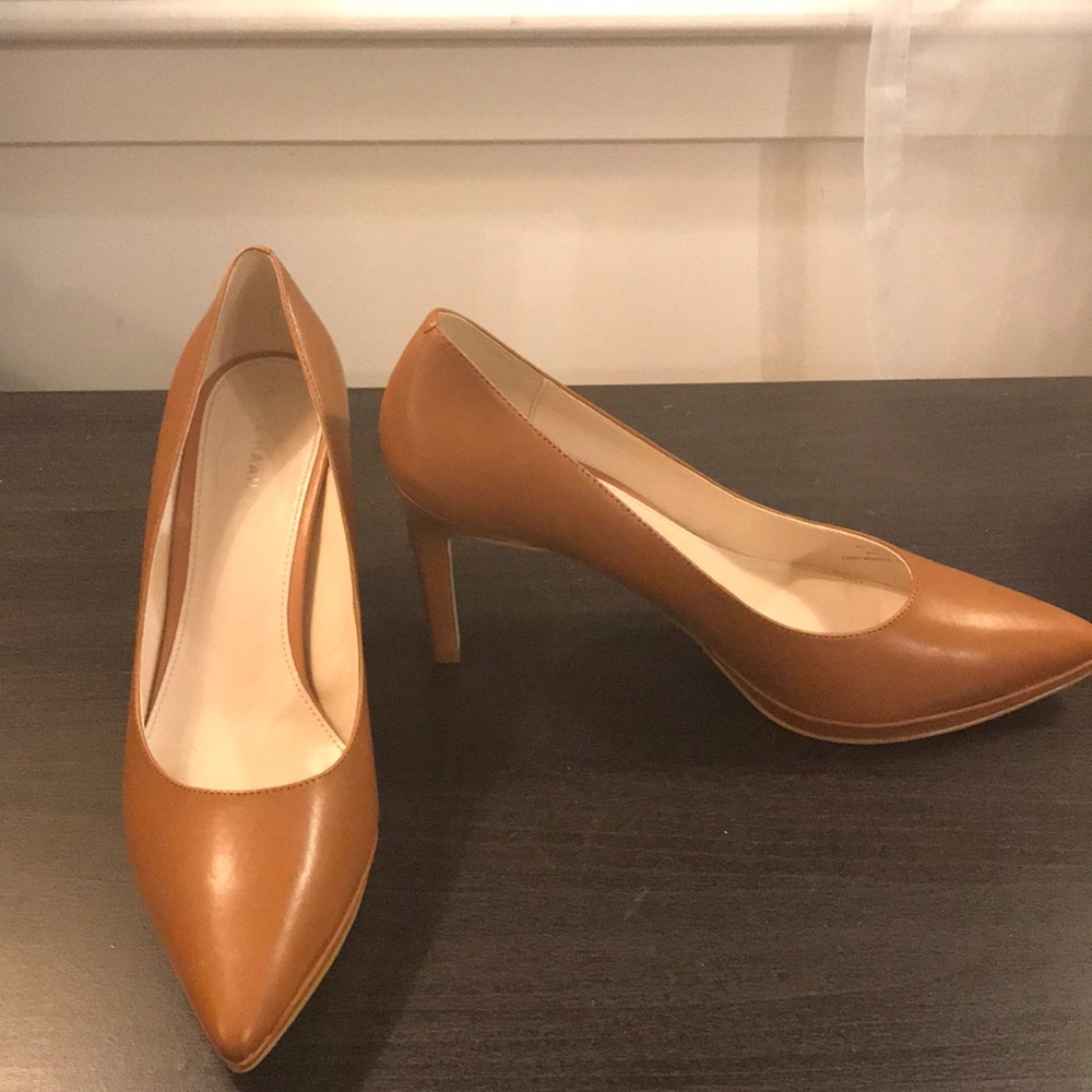 Tan closed toed pumps